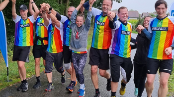 A diverse group of individuals crossing the finish line